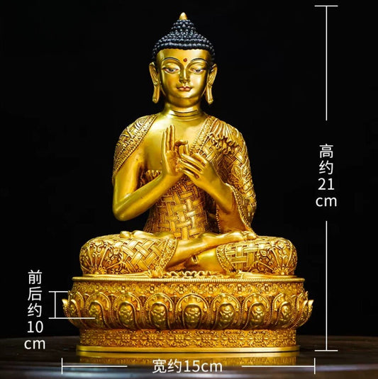 A gilded statue of Shakyamuni Buddha on the shrine at Tashi Gephelling Buddhist Centre