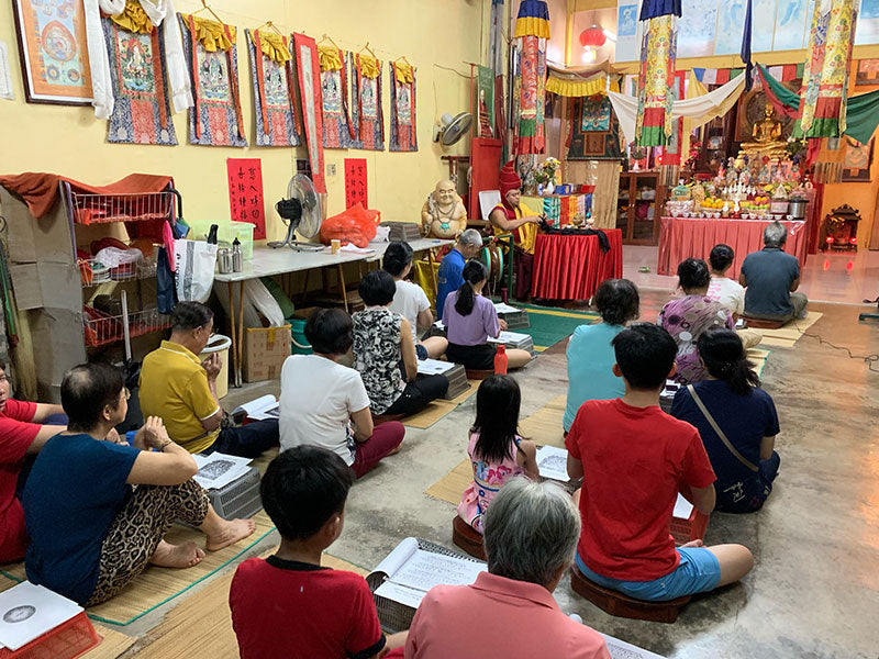 Monks and community gathered for prayer and offering at Tashi Gephelling Buddhist Centre