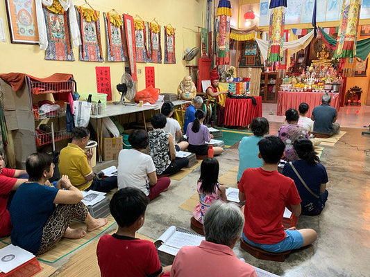 Monks and community gathered for prayer and offering at Tashi Gephelling Buddhist Centre