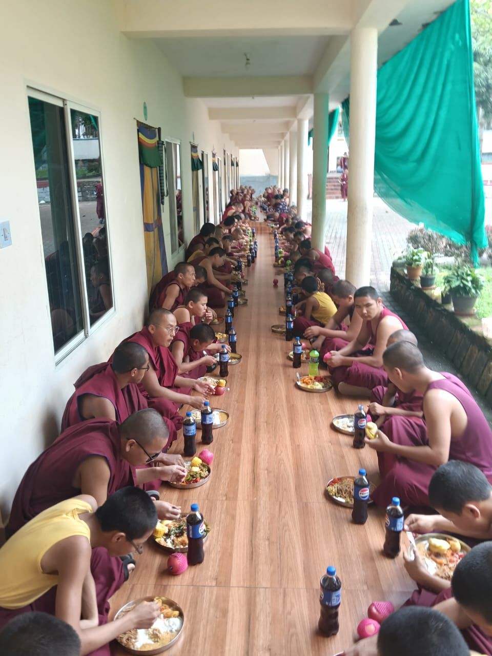 Monks of Sera Monastery receiving a sponsored meal offering