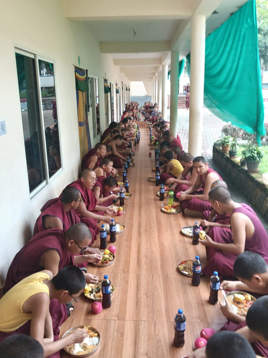 Monks of Sera Monastery receiving a sponsored meal offering