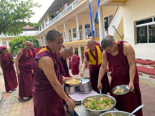 Monks of Sera and Drepung monasteries receiving a sponsored meal offering
