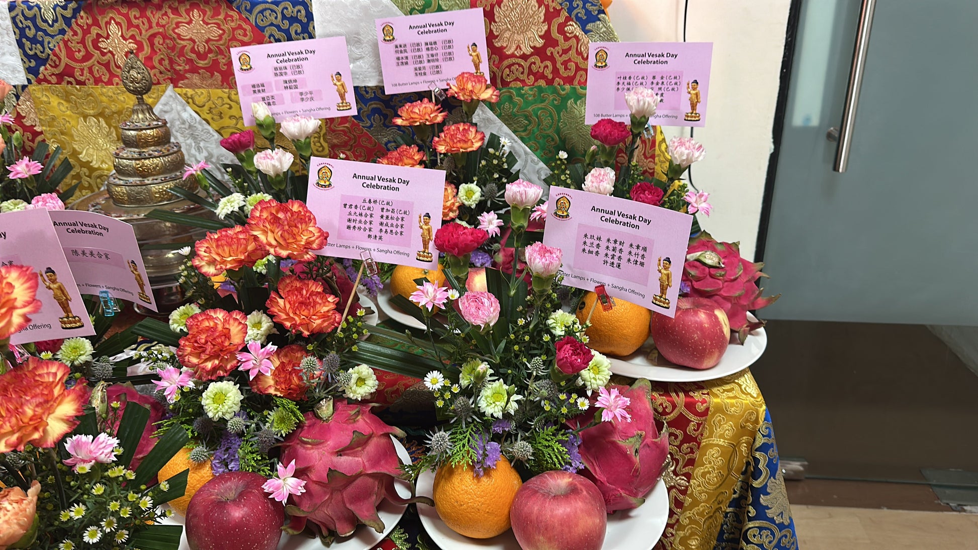 Flower offerings and dedication cards at Tashi Gephelling Buddhist Centre