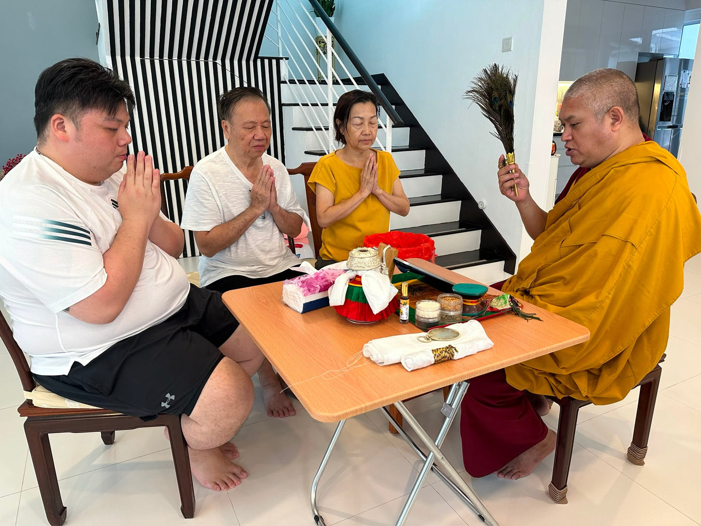 Bise Rinpoche performing a house blessing ceremony for a family at home