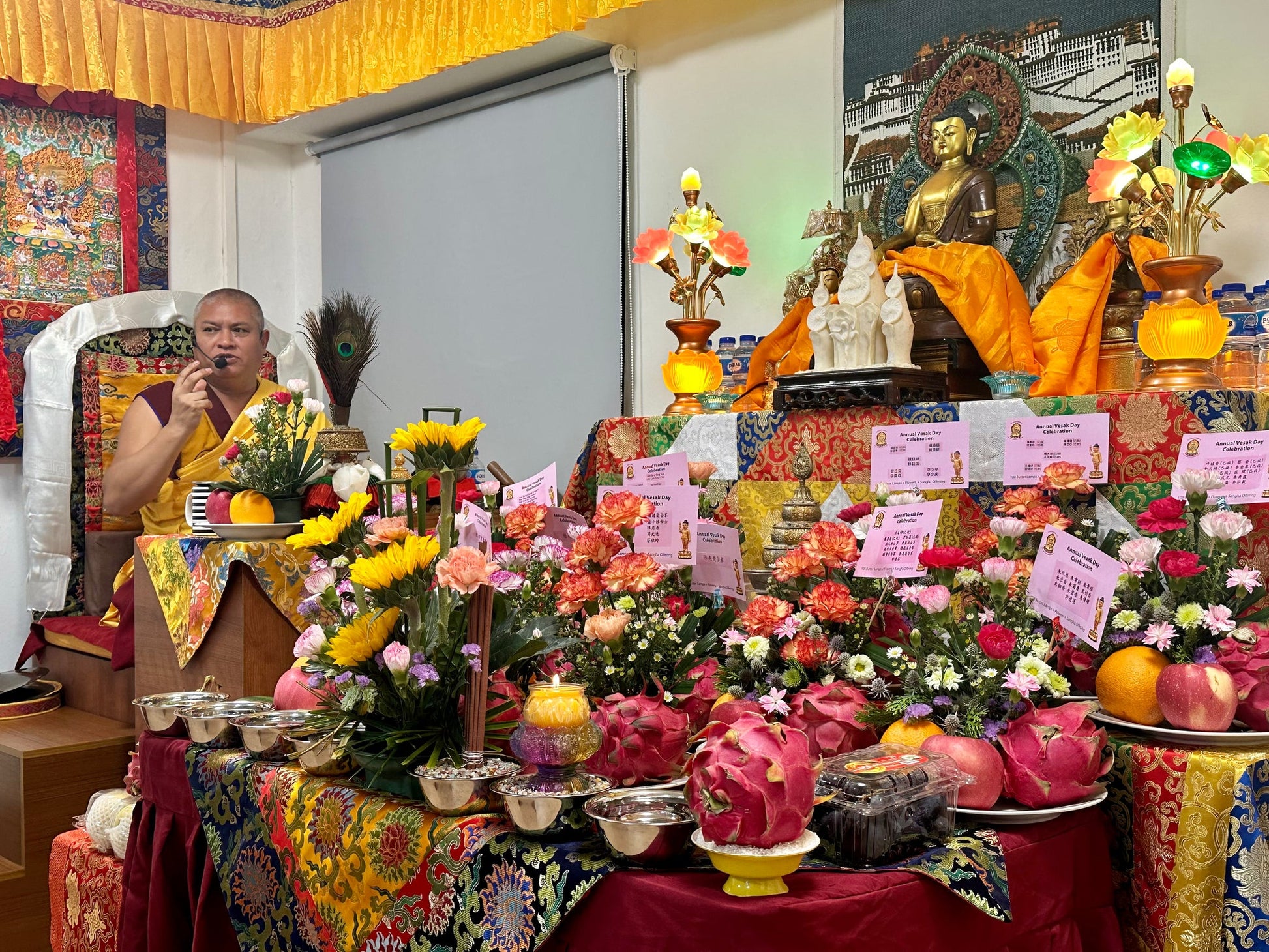 The Buddha altar at Tashi Gephelling Buddhist Centre with flower and fruit offerings